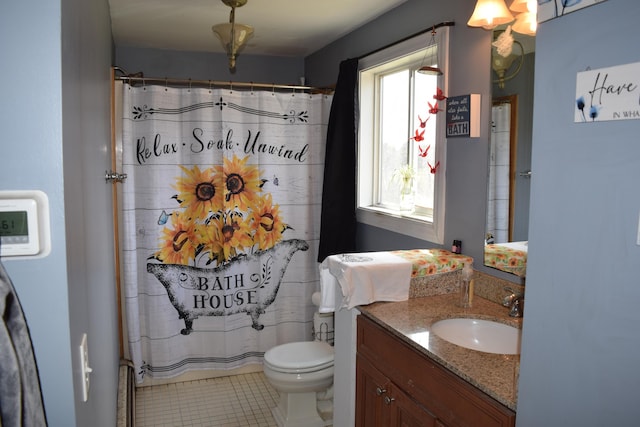 bathroom featuring toilet, curtained shower, tile patterned flooring, and vanity