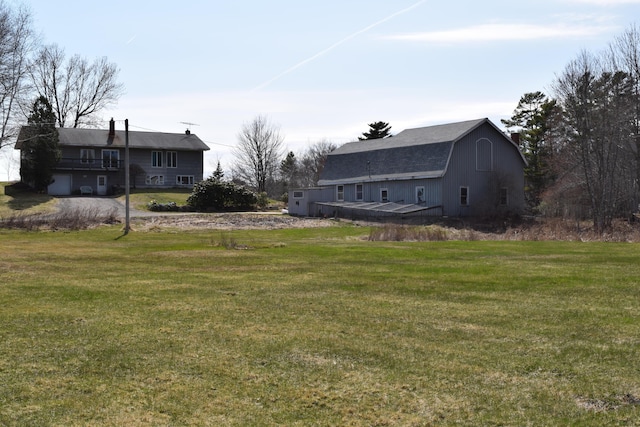 view of yard featuring a barn and an outbuilding