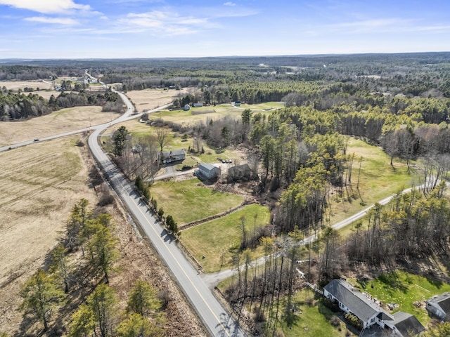bird's eye view with a wooded view
