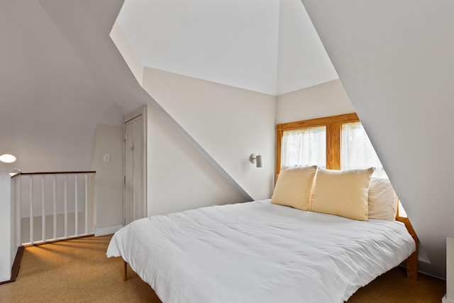 carpeted bedroom featuring lofted ceiling