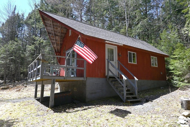 14 Mountain Stream Ln, Moscow, ME 04920 - view of front facade with a deck, roof with shingles, entry steps, and crawl space