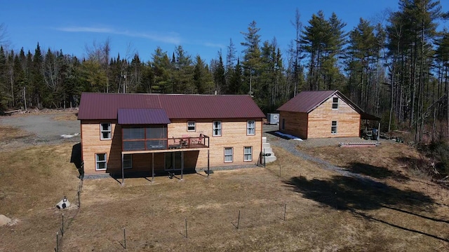 476 N Rd, Medford, ME 04463 - back of property with a deck, metal roof, and a forest view