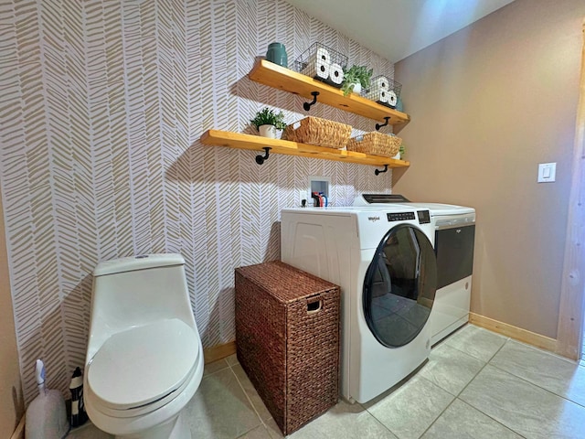 476 N Rd, Medford, ME 04463 - clothes washing area with washing machine and clothes dryer, light tile patterned floors, wallpapered walls, and baseboards