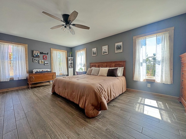 476 N Rd, Medford, ME 04463 - bedroom featuring baseboards, ceiling fan, multiple windows, and wood finished floors