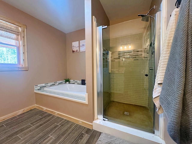 476 N Rd, Medford, ME 04463 - full bath with baseboards, a stall shower, a bath, and wood finished floors
