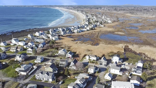 aerial view featuring a view of the beach, a residential view, and a water view