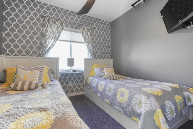 bedroom featuring ceiling fan, vaulted ceiling, wallpapered walls, and carpet