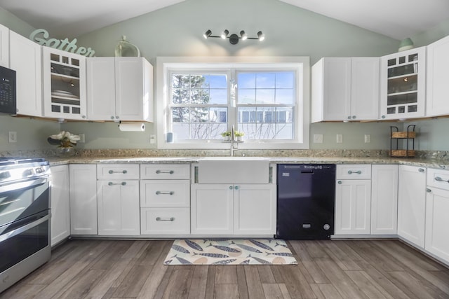 kitchen with dark wood finished floors, black appliances, vaulted ceiling, and a sink