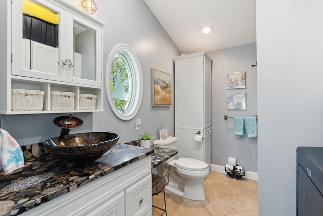 17 Clifford Ln, Wells, ME 04090 - bathroom with vanity, toilet, tile patterned flooring, baseboards, and lofted ceiling