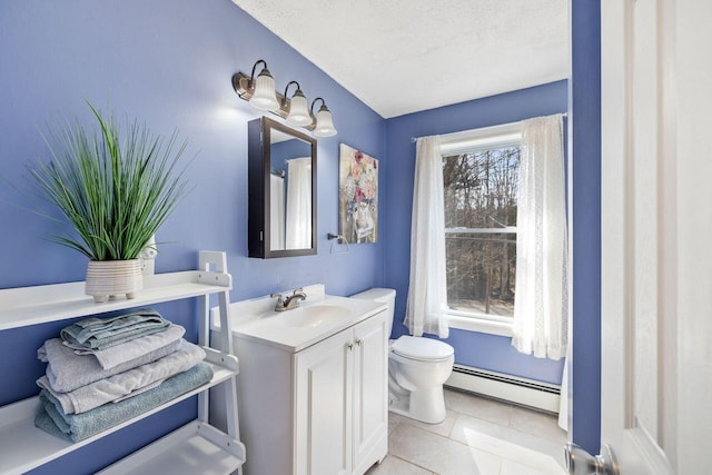 bathroom with tile patterned floors, toilet, vanity, a textured ceiling, and baseboard heating