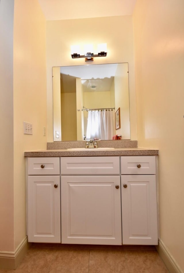 bathroom with baseboards and vanity