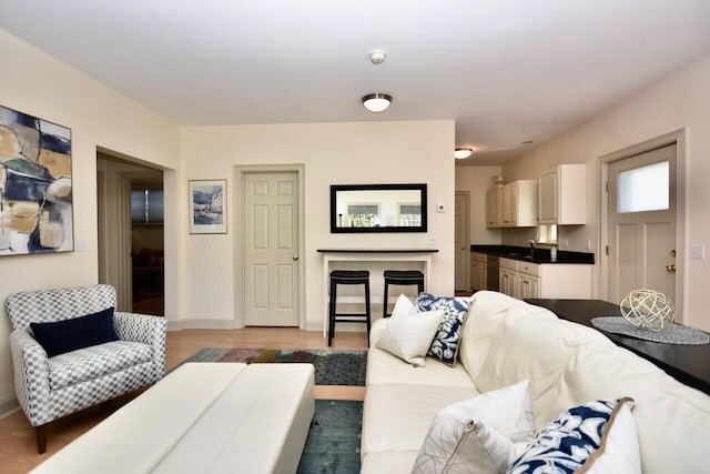 living area with light wood-style flooring and baseboards