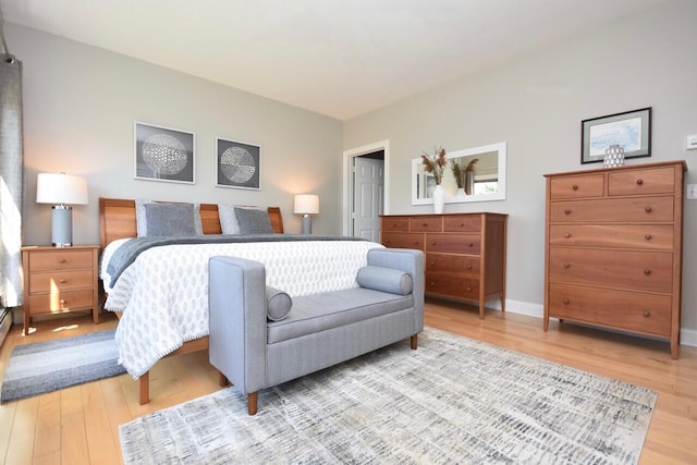 bedroom with baseboards and light wood-style flooring