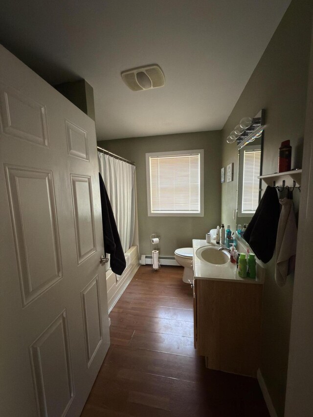 103 Fyfe Rd, Farmington, ME 04938 - full bath featuring wood finished floors, visible vents, toilet, vanity, and a baseboard radiator