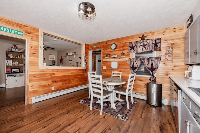44 Sunset Ave, Wilton, ME 04294 - dining room with a baseboard heating unit, dark wood-style floors, and wooden walls