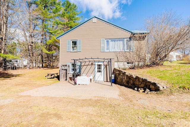 44 Sunset Ave, Wilton, ME 04294 - back of property featuring a lawn, a pergola, and a patio
