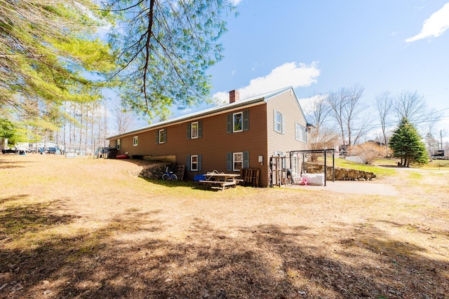 44 Sunset Ave, Wilton, ME 04294 - back of house with a chimney