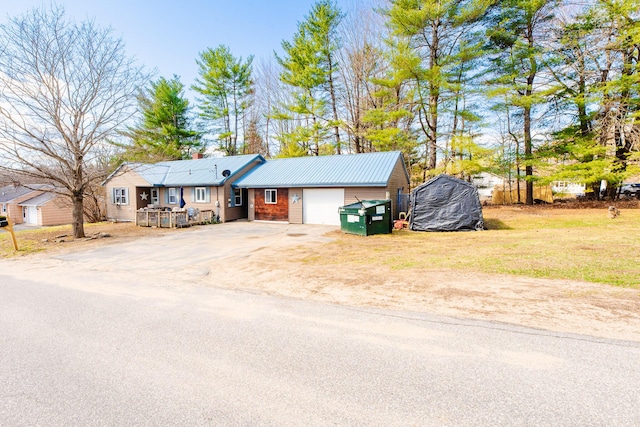 44 Sunset Ave, Wilton, ME 04294 - ranch-style home featuring a garage, driveway, and metal roof