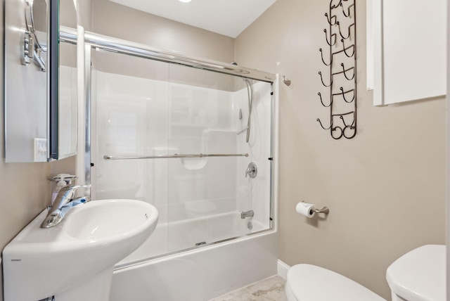 35 Barefoot Cottage Rd Unit 163, Wells, ME 04090 - bathroom with baseboards, toilet, a sink, and combined bath / shower with glass door