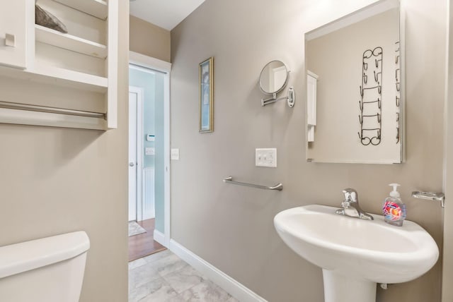 35 Barefoot Cottage Rd Unit 163, Wells, ME 04090 - half bathroom featuring marble finish floor, toilet, a sink, and baseboards