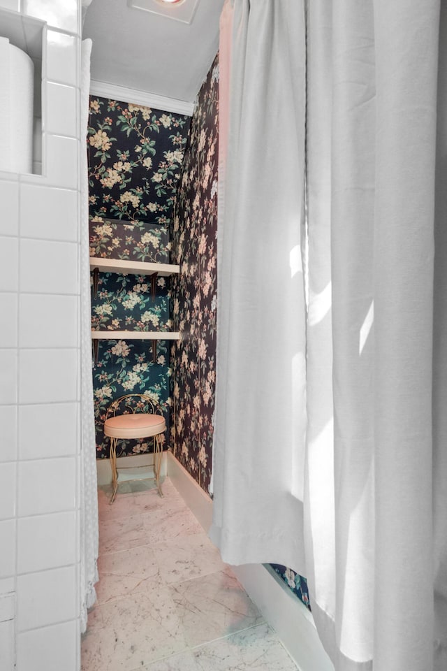 bathroom featuring baseboards and wallpapered walls