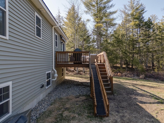 view of jungle gym featuring a wooden deck and stairs