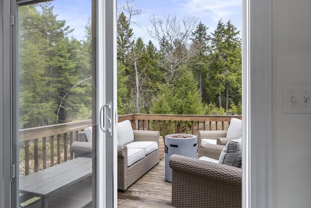 exterior space featuring a forest view and an outdoor living space