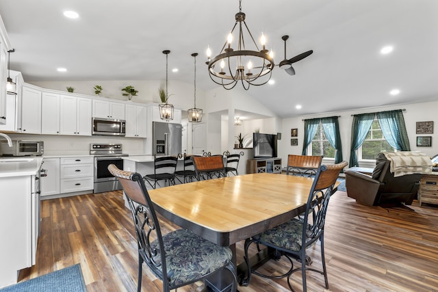 dining room with a chandelier, lofted ceiling, dark wood-type flooring, and recessed lighting