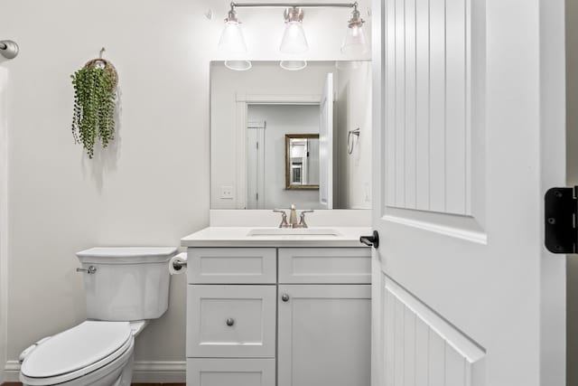 half bathroom featuring toilet and vanity