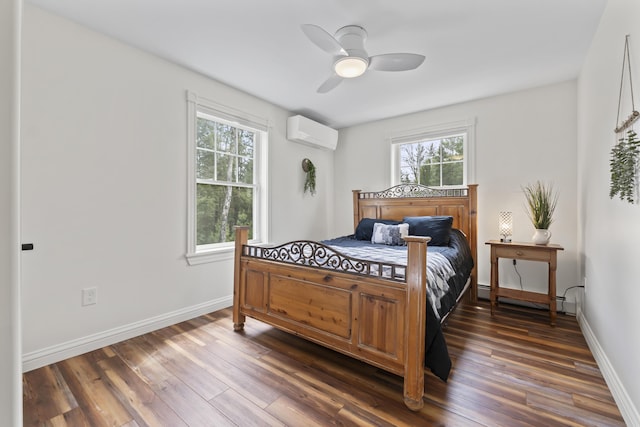 bedroom featuring a baseboard heating unit, dark wood-style flooring, a wall unit AC, and multiple windows