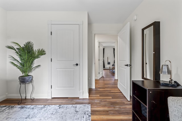 interior space featuring baseboards and wood finished floors