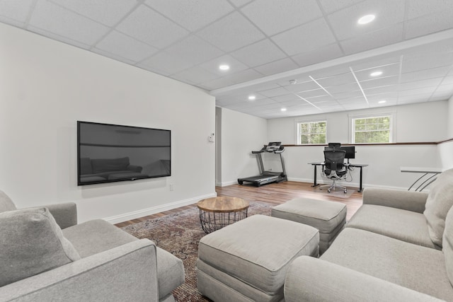 living room featuring wood finished floors, a paneled ceiling, and recessed lighting