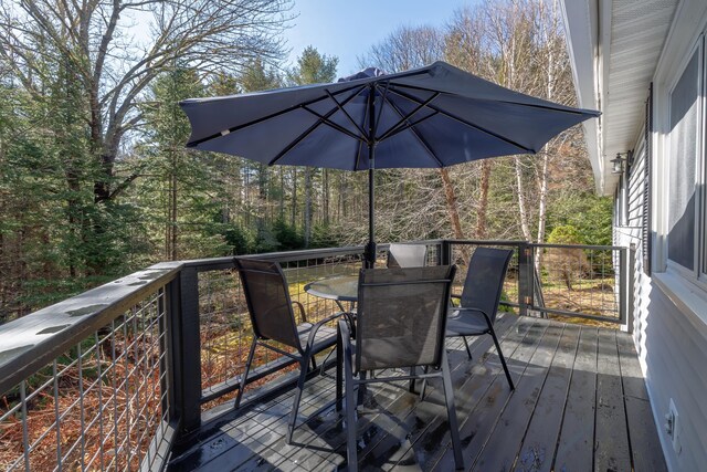 wooden deck with outdoor dining area