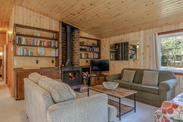 living room with lofted ceiling, a wood stove, wood walls, and light colored carpet