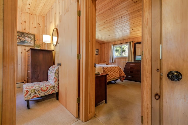 bedroom featuring baseboard heating, wooden walls, wood ceiling, carpet, and lofted ceiling