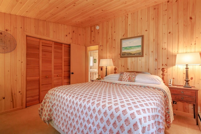 bedroom featuring wooden walls, carpet floors, a closet, and wood ceiling
