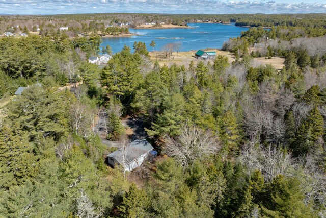 birds eye view of property featuring a view of trees and a water view