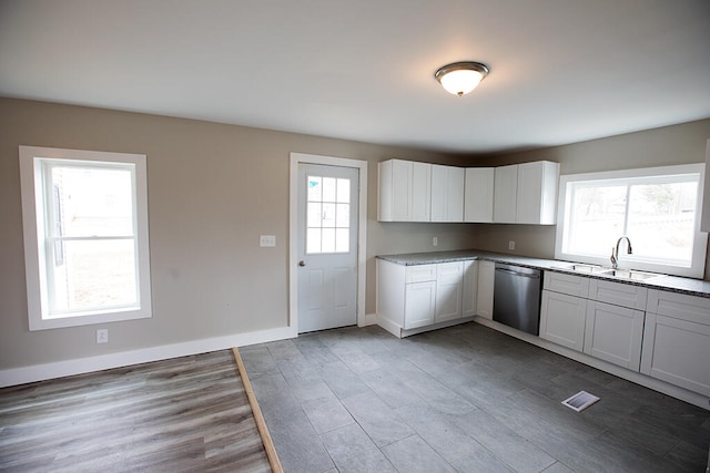 179 Main St, Corinth, ME 04427 - kitchen featuring white cabinets, stainless steel dishwasher, a sink, and light wood-style flooring