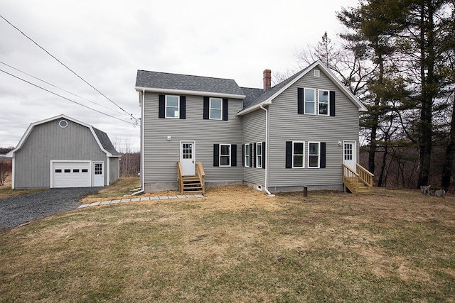 179 Main St, Corinth, ME 04427 - rear view of property featuring an outdoor structure, a detached garage, entry steps, and a lawn