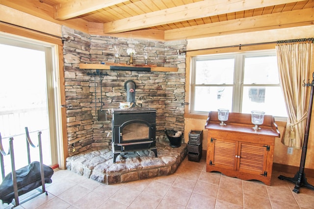 54 Folsom Ridge Rd, Burlington, ME 04417 - living area with a wood stove, beamed ceiling, tile patterned flooring, and wooden ceiling