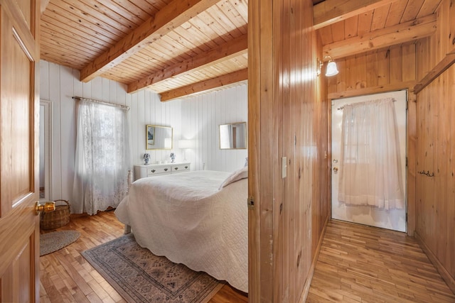 54 Folsom Ridge Rd, Burlington, ME 04417 - bedroom with beam ceiling, wooden walls, hardwood / wood-style flooring, and wood ceiling