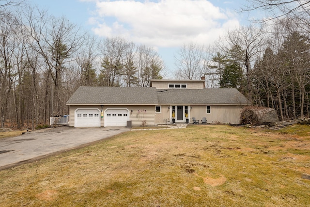 31 Pulpit Rock Rd, Raymond, ME 04071 - mid-century modern home featuring asphalt driveway, an attached garage, a front yard, a chimney, and a shingled roof