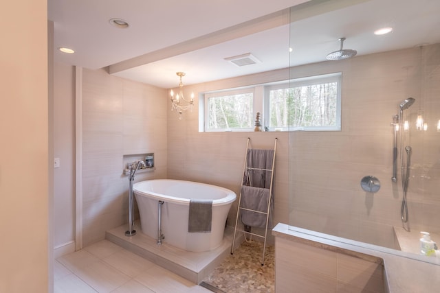 31 Pulpit Rock Rd, Raymond, ME 04071 - full bath with a freestanding tub, walk in shower, tile patterned flooring, recessed lighting, and tile walls