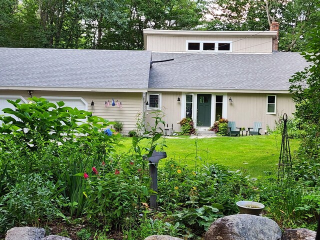 31 Pulpit Rock Rd, Raymond, ME 04071 - back of property with a shingled roof, a lawn, and a chimney