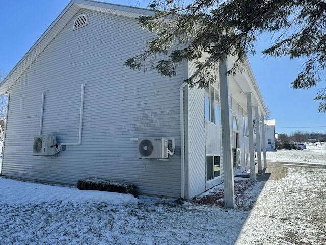 view of snow covered exterior with ac unit
