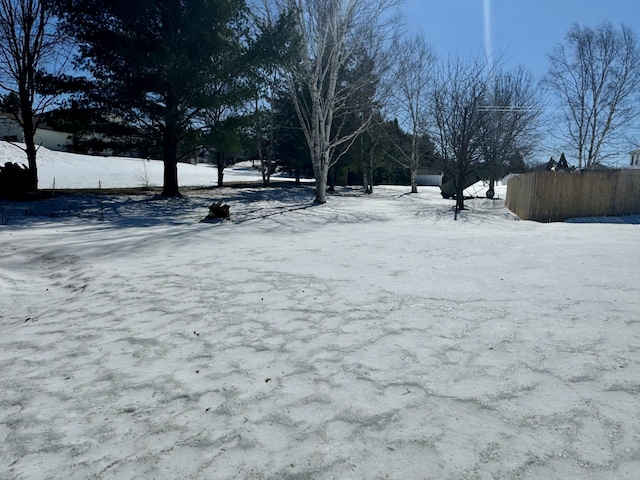 yard layered in snow with fence