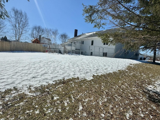 snowy yard with fence