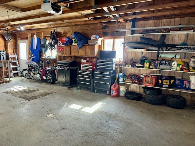 garage with wooden walls and a garage door opener