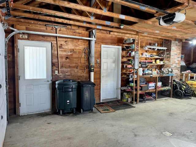 garage featuring wood walls and a garage door opener