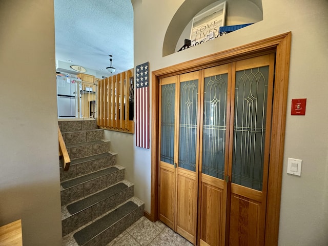 stairs with tile patterned floors